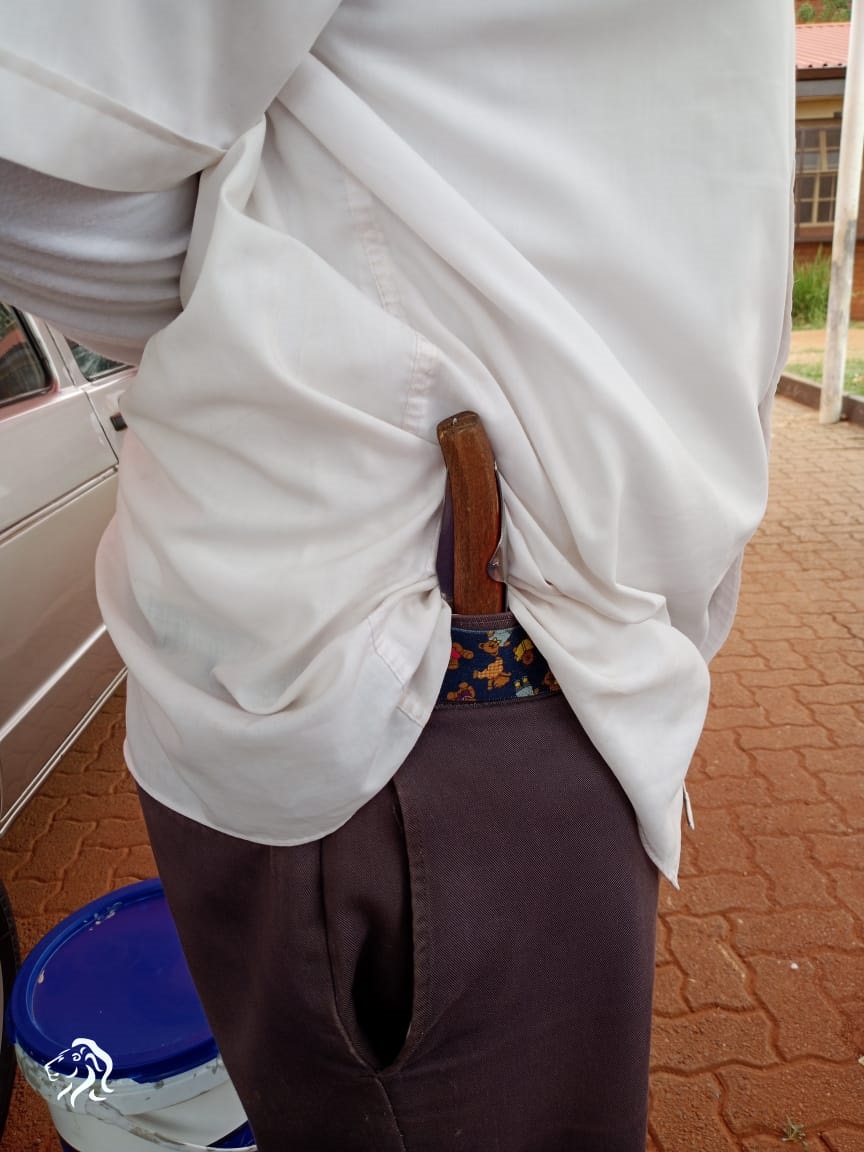 A pupil showing off a knife at school. Photo by Sammy Moretsi