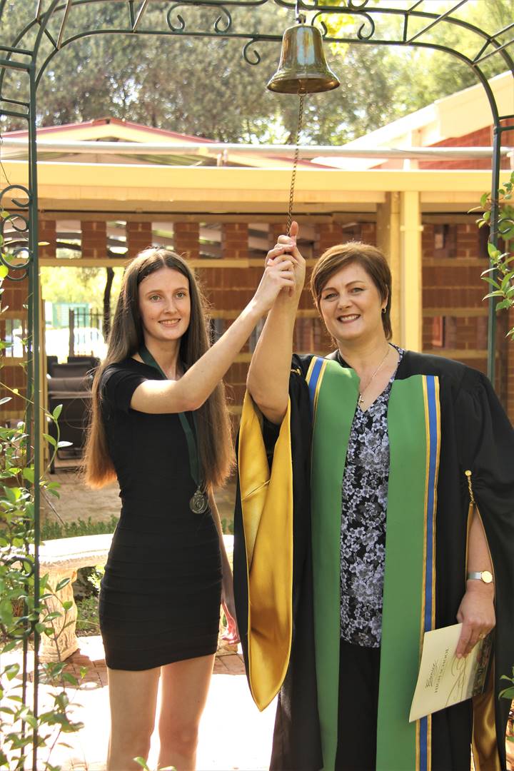 Free State top matriculant for 2022 Emma Nel (left) and Zinnette de Wet (principal of the Eunice High School) rings the bell to announce the end of the matriculants of 2022’s school careers. Photo: Lientjie Mentz