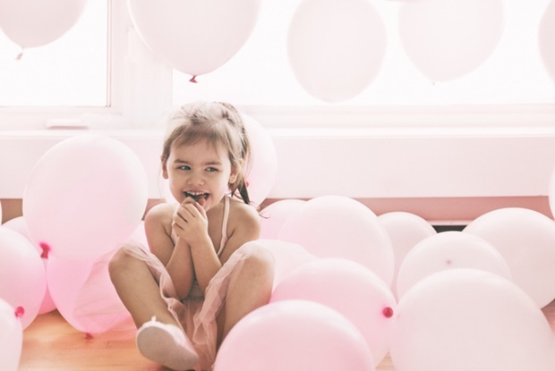 Little girl with pink balloons