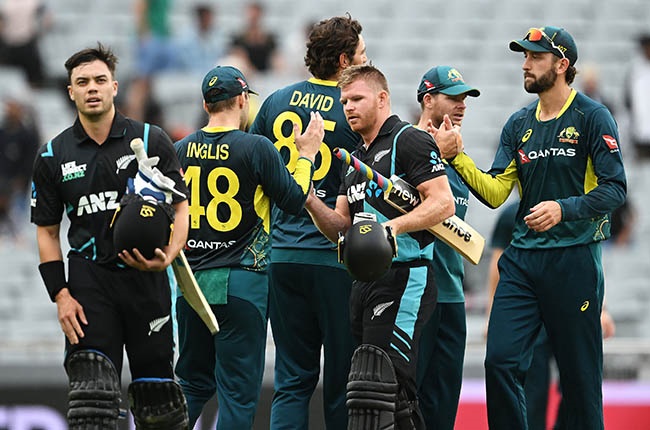 Mark Chapman and Glenn Phillips of New Zealand shake hands with the Australian players after game three of their T20 series (Photo by Hannah Peters/Getty Images)