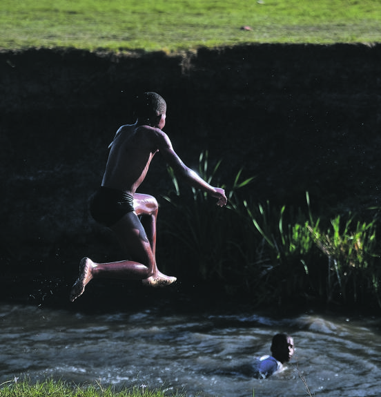 POTENTIALLY DANGEROUS A group of children swim in a dirty river in Vereeniging. Health risks have been raised because of water contamination in the area. Picture: Rosetta Msimango