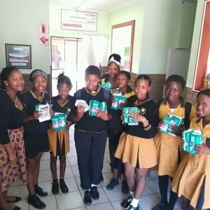 Queening CEO, Sibongile Mngxitama with learners at Nanogang Primary School