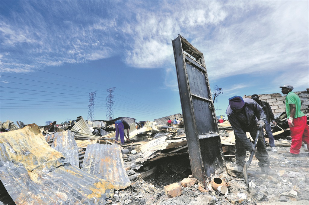 NOTHING LEFT A door stands as the only structure left, following a fire that left many homeless at an informal settlement on London road, next to Alexandra township. Picture: Leon Sadiki 