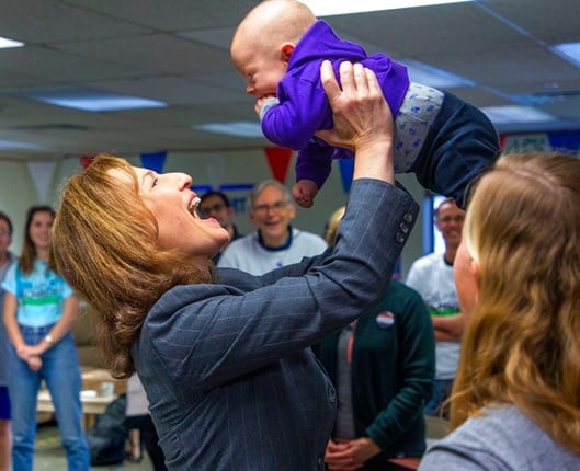 <em>Democrat Kim Schrier, running for Congress in Washington's 8th District, greets volunteers, including four-month-old Griffin Staniar, the son of a campaign volunteer, at her campaign office in Issaquah on election day. (Mike Siegel/The Seattle Times via AP)</em>