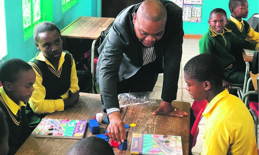 Dr Phi Makgoe, MEC for the Free State Department of Education. speaks to pupils from SHS Mofube Primary School in one of the school’s new classrooms.