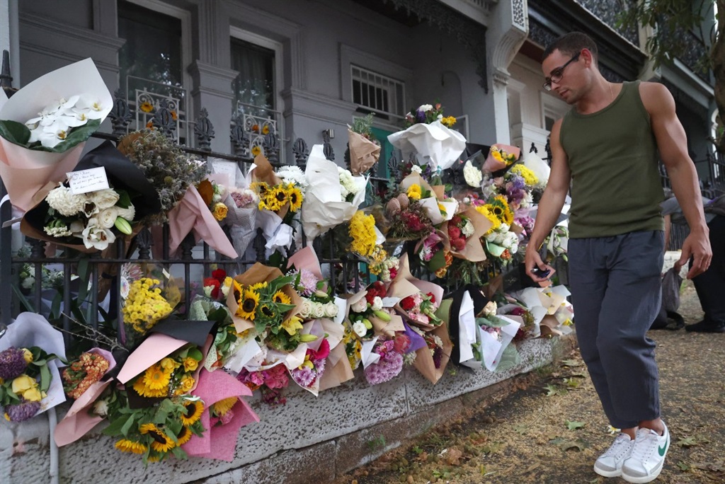 Floral tributes left by mourners are seen outside the shared residence of entertainment journalist Jesse Baird in the Sydney suburb of Paddington on 27 February 2024. (Saeed KHAN / AFP)