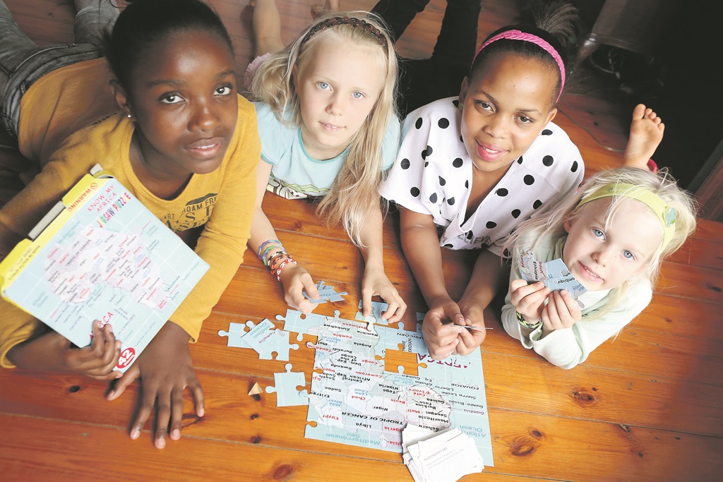  From left: Hope Miller (11), Helena Hattingh (8), Snethemba Mkhize (11) and Genevieve Hattingh (6) have fun learning about our continent and its countries while playing Know My Africa, invented by Durban-based Khangelani Gama Picture: Matthew Hattingh