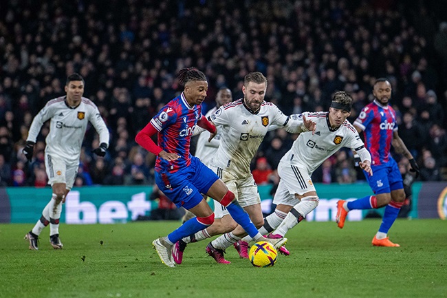 Crystal Palace's Michael Olise  dribbles around Luke Shaw and Lisandro Martinez of Manchester United during the Premier League match at Selhurst Park on 18 January 2023. (Sebastian Frej/MB Media/Getty Images)