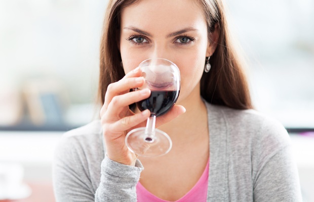Woman drinking glass of red wine 