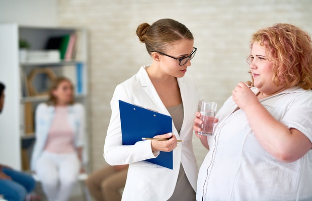 Doctor talking to obese woman 
