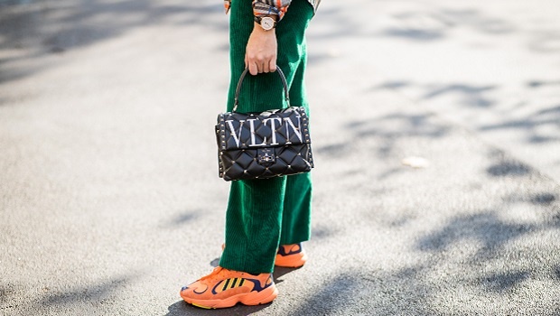 Sonia Lyson wearing dark green corduroy pants Isabel Marant and neon yellow orange sneaker in Berlin