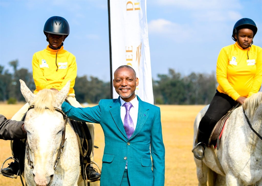MEC for Sport, Art, and Culture Dr Ntuthuko Mahlaba with some horses and jockeys that will participate in Dundee July. 