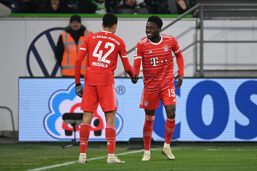WOLFSBURG, GERMANY - FEBRUARY 05: Jamal Musiala of Bayern Munich celebrates with teammate Alphonso Davies after scoring the teams fourth goal during the Bundesliga match between VfL Wolfsburg and FC Bayern MÃ¼nchen at Volkswagen Arena on February 05, 2023 in Wolfsburg, Germany. (Photo by Stuart Franklin/Getty Images)