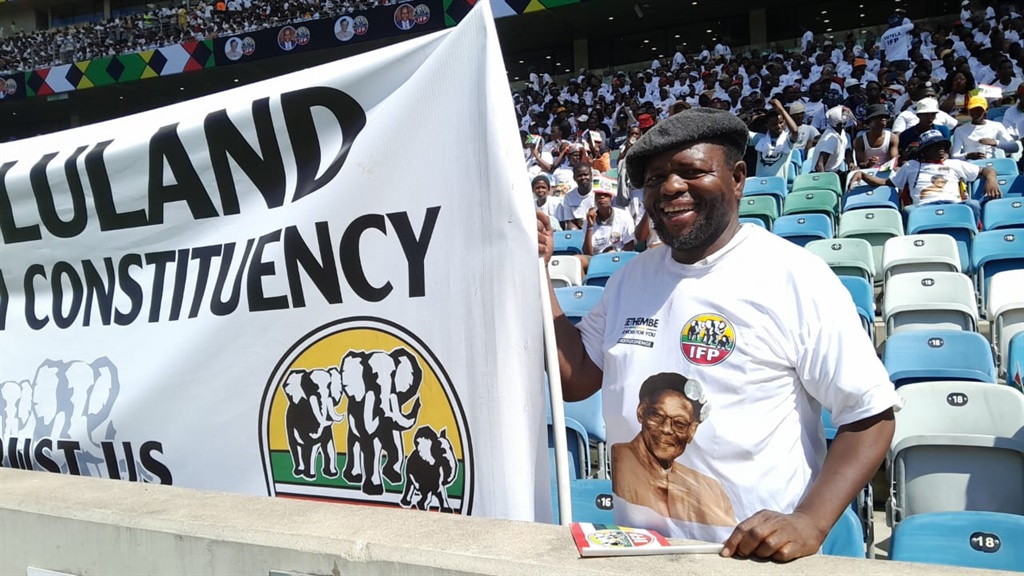 IFP supporter Betwell Mntambo hoists a party flag at the rally in the Moses Mabhida Stadium on Sunday. (Soyiso Maliti/News24)