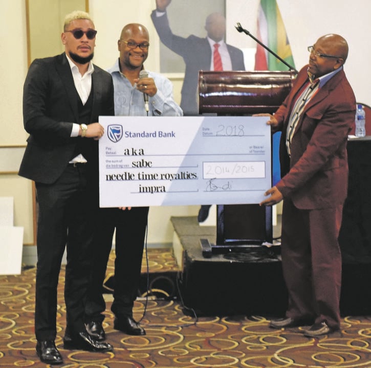 pay day AKA receives a mock cheque of his royalties – handed over by Minister of Arts and Culture Nathi Mthethwa and Impra’s Thabang Mathibe                   PHOTOs: TEBOGO LETSIE
