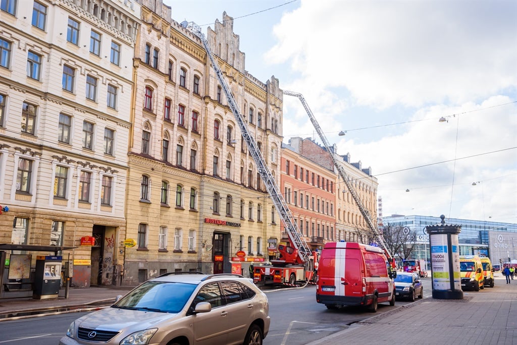 Firefighters work at the site of a blaze in the city centre of Riga, Latvia, on 28 April, 2021. According to firefighters in Latvia’s capital Riga, 8 people died and 9 were injured in a fire at a hostel.