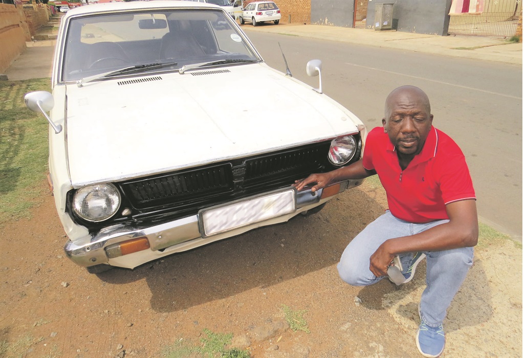 Nkosana Sosibo and his cream-white Toyota Corona.   Photos by Sammy Moretsi