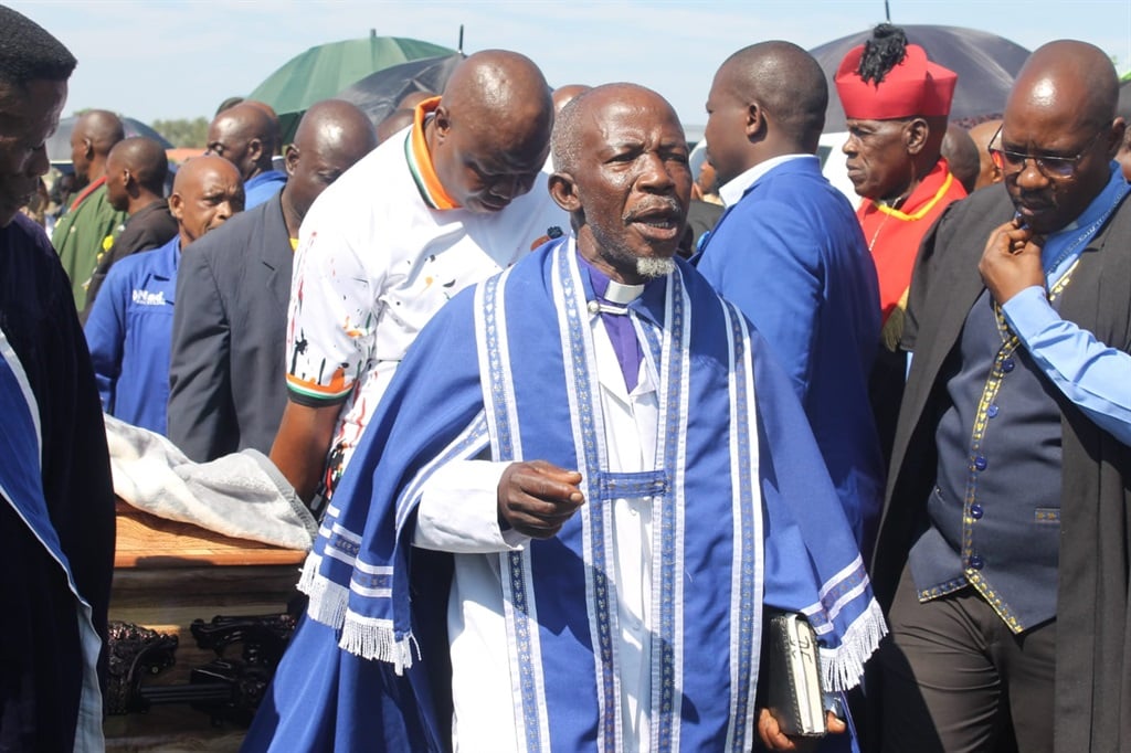 One of the Pastors leading a procession at the gra