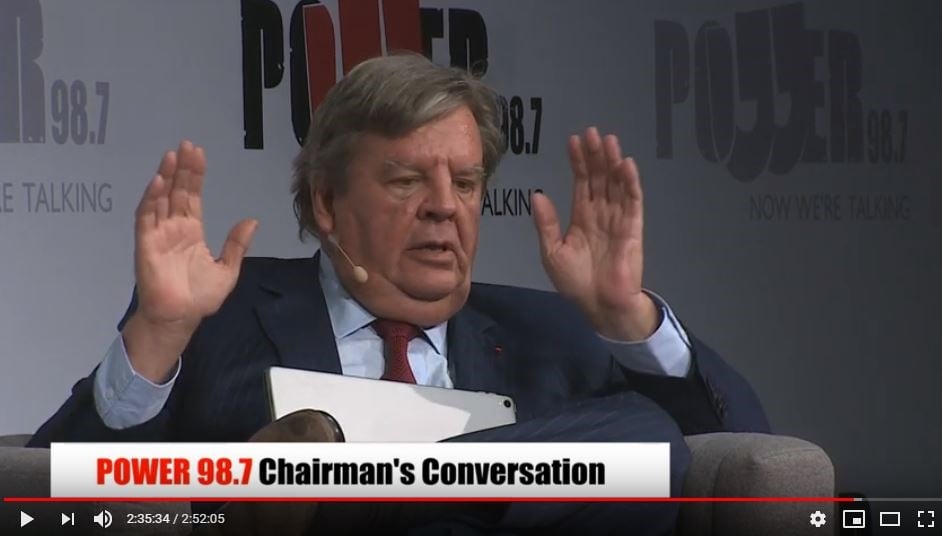 Johann Rupert throws his hands in the air after being called racist during an interview hosted by PowerFM.