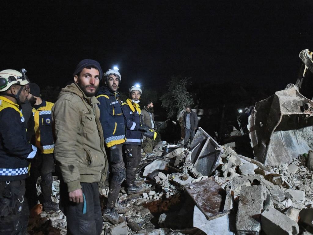 Members of the Syrian civil defence, known as the White Helmets, work at the rubble of a collapsed building in the town of Jandairis.