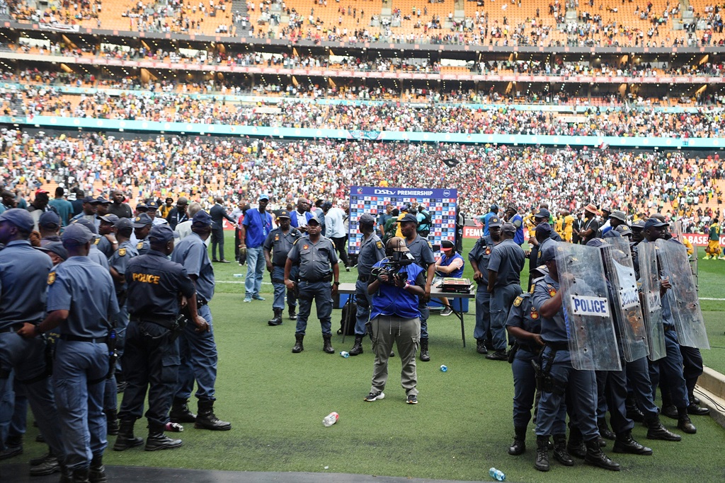 Police and fans during the DStv Premiership match between Orlando Pirates and Kaizer Chiefs at FNB Stadium on March 09, 2024 in Johannesburg, South Africa. 