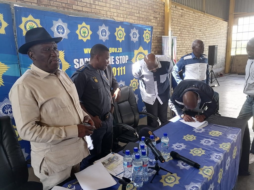 Police Minister Bheki Cele along with provincial police commissioner Lieutenant-General Nhlanhla Mkhwanazi witnessing the signing of the agreement by different taxi operators.