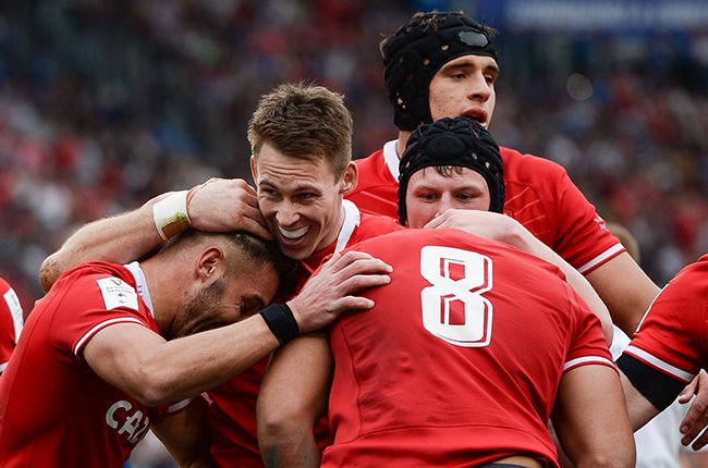 Taulupe Faletau of Wales celebrates with teammate Liam Williams and others after scoring. (Photo by Silvia Lore/Getty Images)