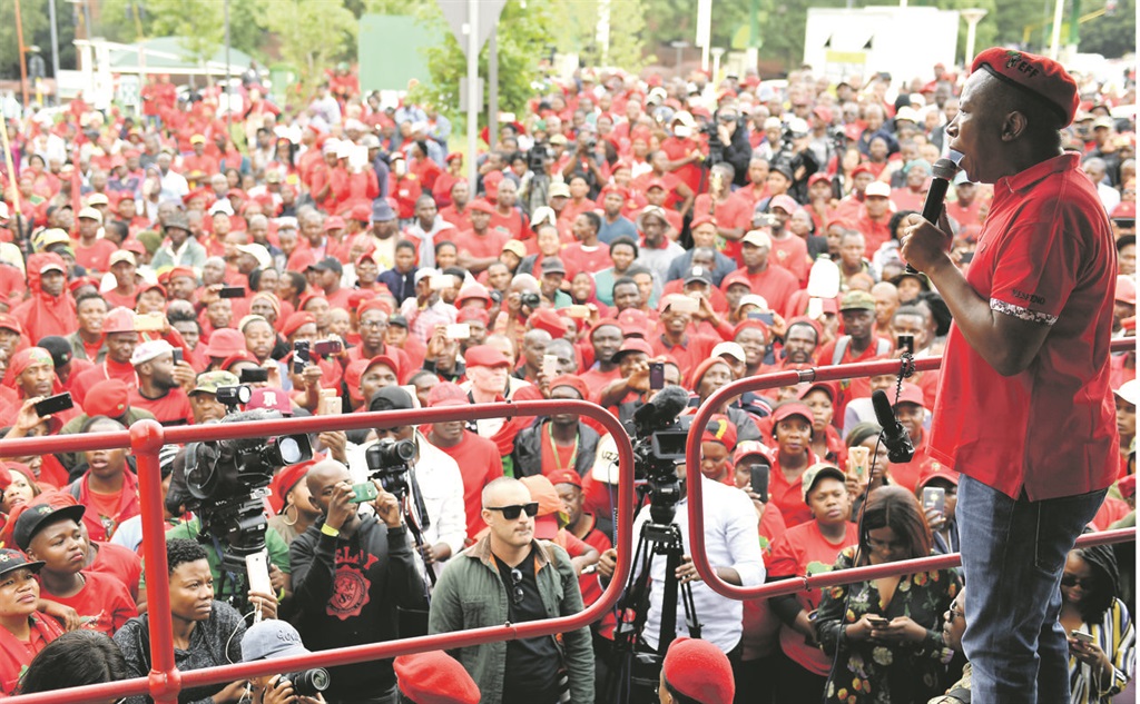 Julius Malema speaks to members of the Economic Freedom Fighters outside the judicial commission of inquiry into state capture in Parktown, Johannesburg, as Public Enterprises Minister Pravin Gordhan testifies Picture: Felix Dlangamandla