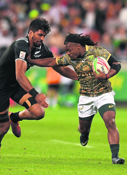 FIGHT FOR IT Branco du Preez makes a break to score a try during day one of the Cape Town Sevens Pool A match 24 against New Zealand at Cape Town Stadium last night. Picture: Ashley Vlotman / Gallo Images