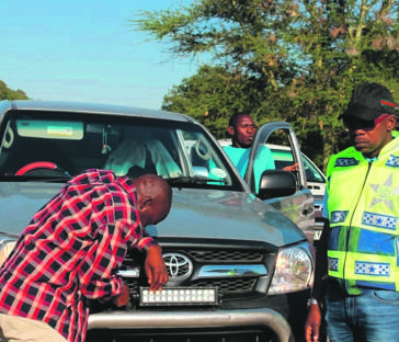 Mpumalanga Community Safety MEC Pat Ngomane helps inspect cars at a road block.Photo by Bulelwa Ginindza