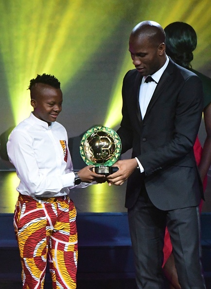 Ivorian soccer player Didier Drogba (R) presents South African Chrestinah Thembi Kgatlana (L) with the Womens Player of the Year trophy during the CAFAWARD 2018 ceremony in Dakar, Senegal