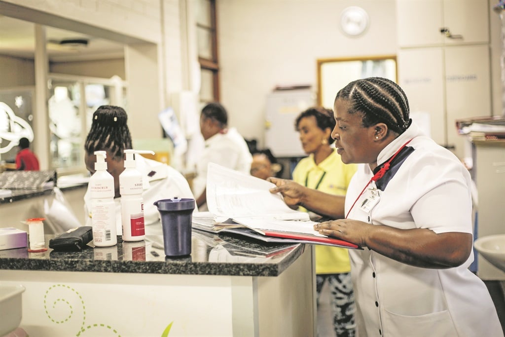 Alis Tshilowa, an auxiliary nurse, reviews one of the patients’ files at Chris Hani Baragwanath Hospital in Soweto Picture: Mpumelelo Buthelezi
