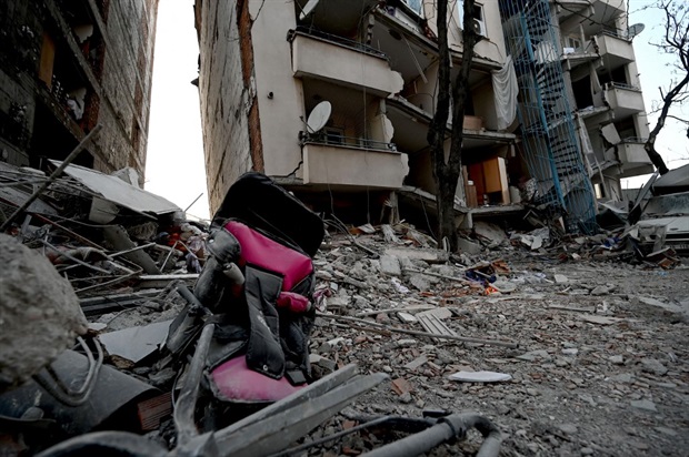 <p>A baby stroller in front of a collapsed building on 12 February 2023 in Kahramanmaras, as rescue efforts start to wind down.<em></em></p><p><em>(PHOTO: OZAN KOSE / AFP)</em></p>