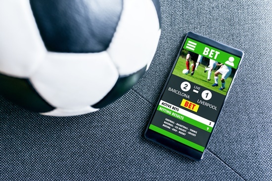 Mobile phone displays a betting app with results a