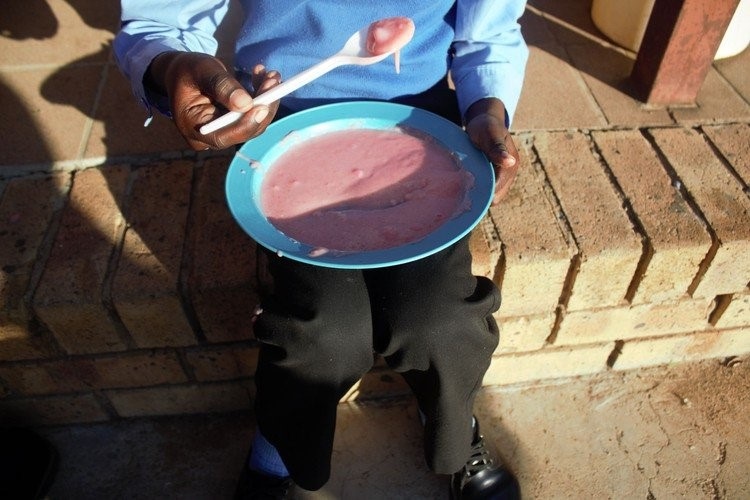 A pupil eats at school.