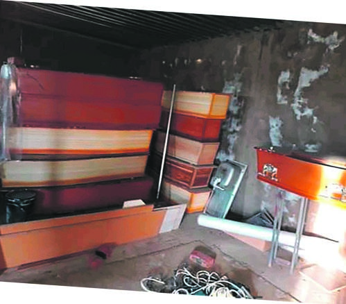 Cops examined the many coffins that were found in a house in Mamehlake.