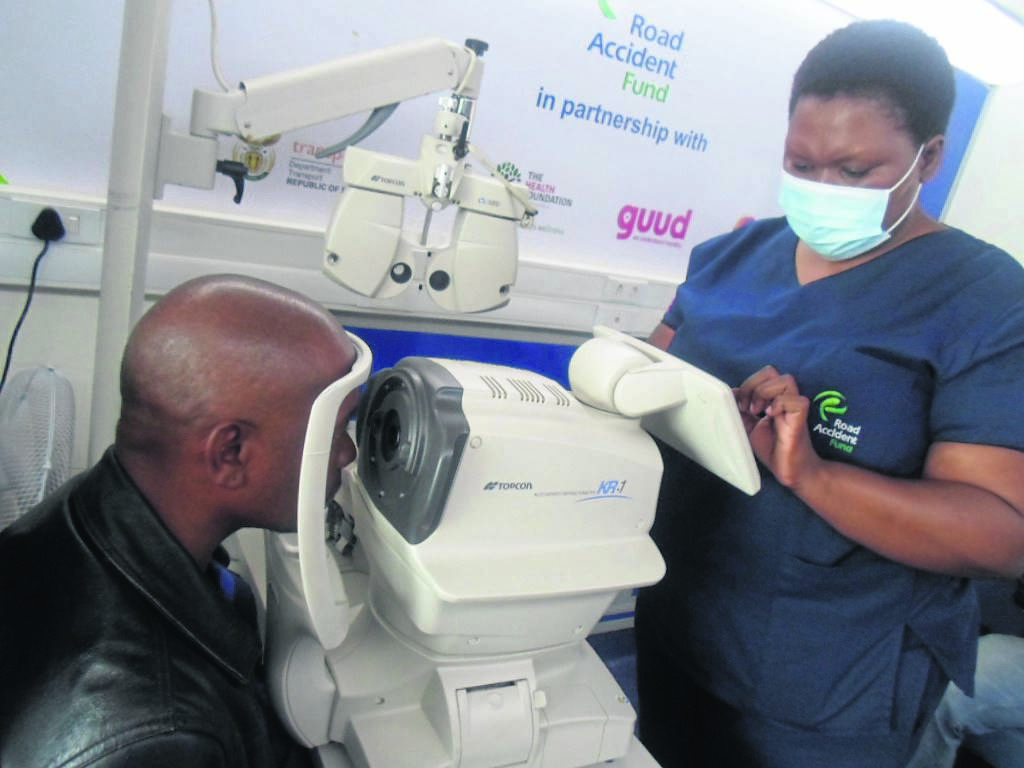 Optometrist Virginia Mohale checking the eyes of a driver from Border Alliance Taxi Association, Silulami Tsawe.                                     