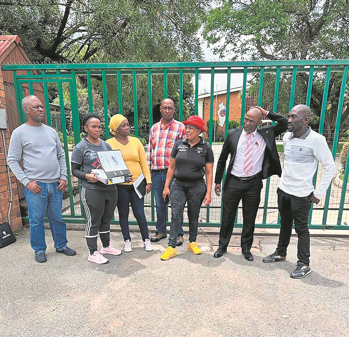The school governing body was seen blocking the school gate.