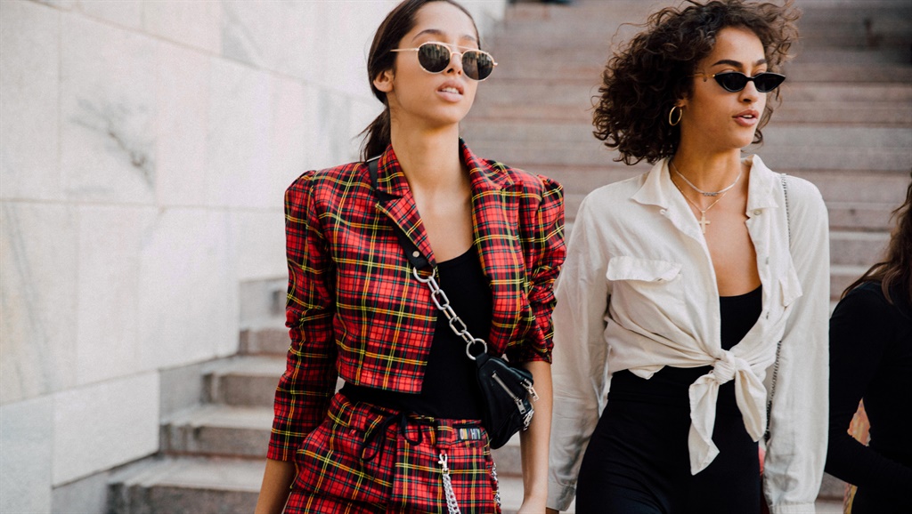 Models Yasmin Wijnaldum, Alanna Arrington walk confidently in their off-white blouses and leather accessories
