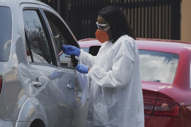 A health professional holds a swab test for the coronavirus at a drive through testing site outside the Lancet Laboratories facilities in Johannesburg. (Marco Longari, AFP)