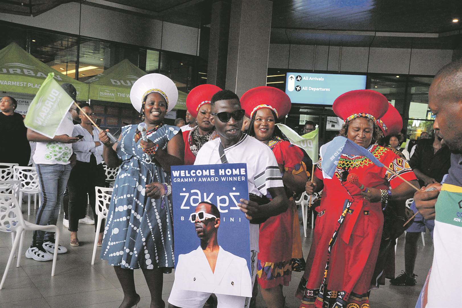 Durban residents and artists sang and danced as they welcomed Grammy award winner Zakes Bantwini (left) to the King Shaka International Airport.            Photos by Jabulani Langa