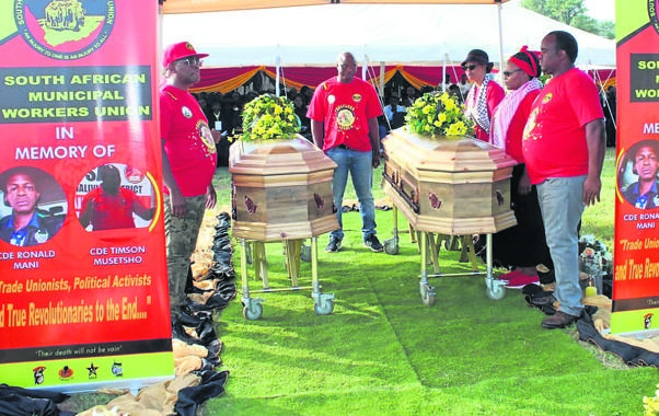 Mourners next to the coffins of Samwu leaders Ronald Mani and Timmy Musetsho during their funeral service at Makhuvha Stadium.                  