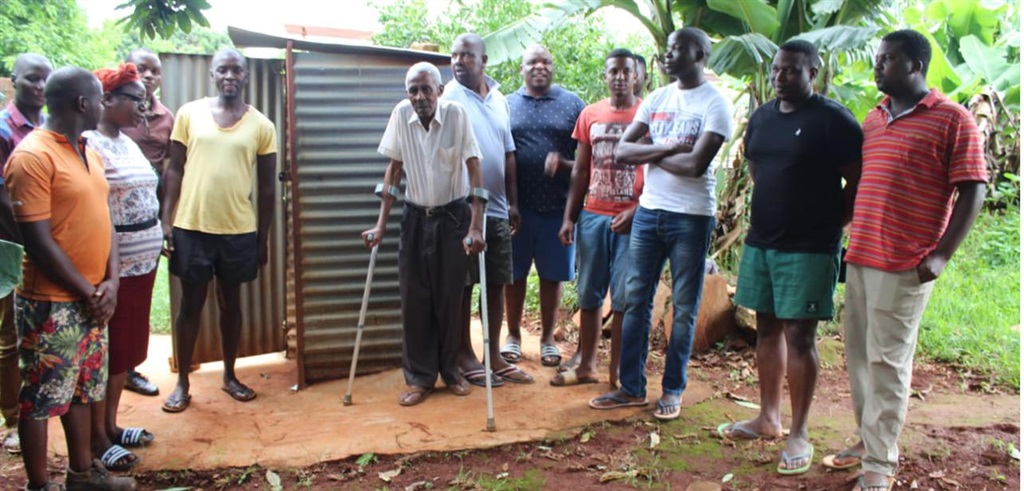 These local youths have changed the life of madala Edward Ladzani (centre) by building him a flushing toilet.                Photo by Armando Chikhudo