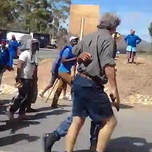 Western Cape police are probing an incident in which a man was caught on camera wielding a firearm during a demonstration in Greyton on Monday. (Supplied)