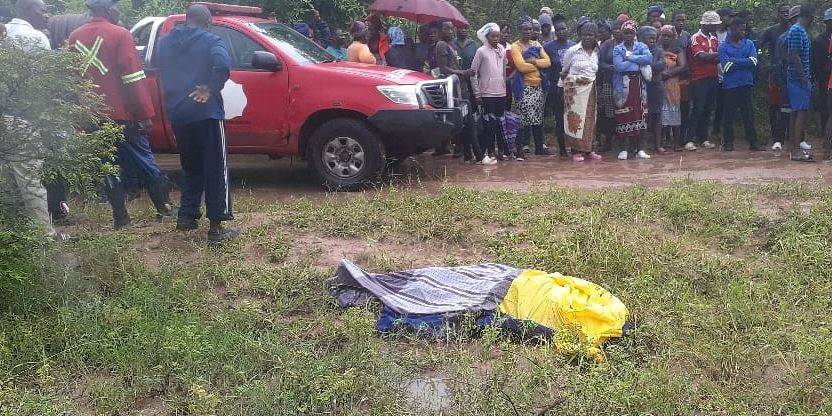 Shocked residents and Mashabane family standing next to the lifeless body of their son  Bifa Mashabane retrieved by the fire and rescue team from Bushbuckridge Municipality and the police from the swollen  river outskirts of Kildare Village. Photo by Oris Mnisi