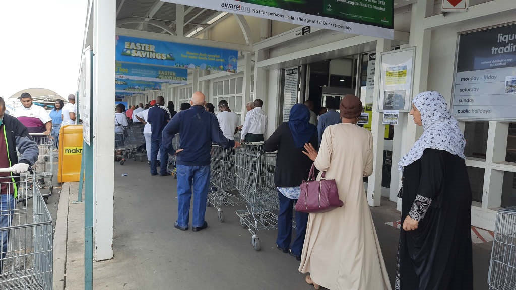 Shoppers standing in snaking queues outside Makro in Crown Mines, Johannesburg on Tuesday, 24 March 2020.