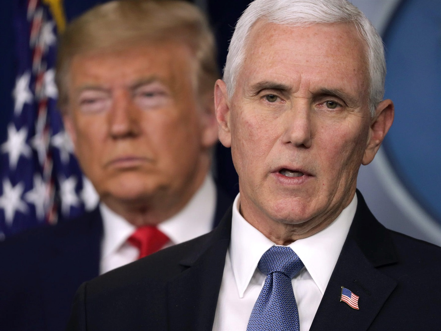 Former US president Donald Trump listens as Vice President Mike Pence speaks at a coronavirus briefing in February 2020. 