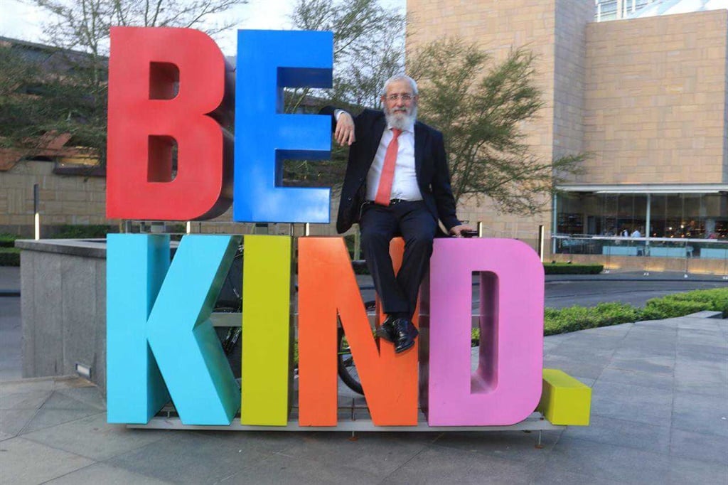Rabbi David Masinter, director of the Miracle Drive annual charity drive and Chabad House poses next to the 'Be Kind' artwork outside Sandton City (Supplied)