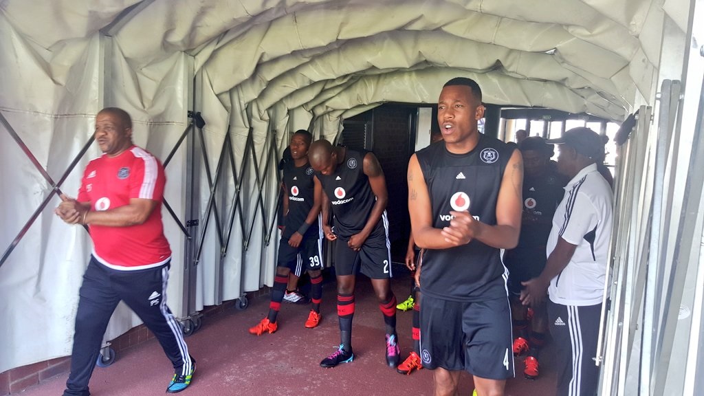 Orlando Pirates kit manager Pule Sithebe and captain Happy Jele leading out the suad.