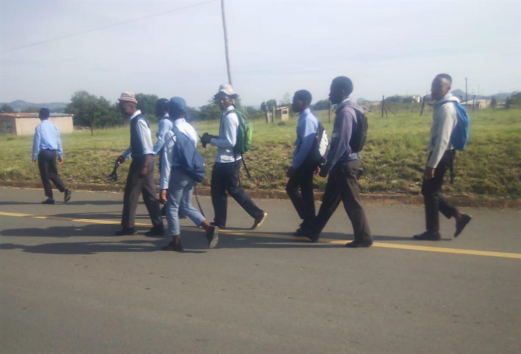 Pupils from Holela Secondary School walk to school after their scholar transport failed to show up.   Photo by Bongani Mthimunye